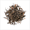 Pile of loose leaf Double Roasted Oolong to show detail of dark and light brown wiry looking full leaf oolong tea. 