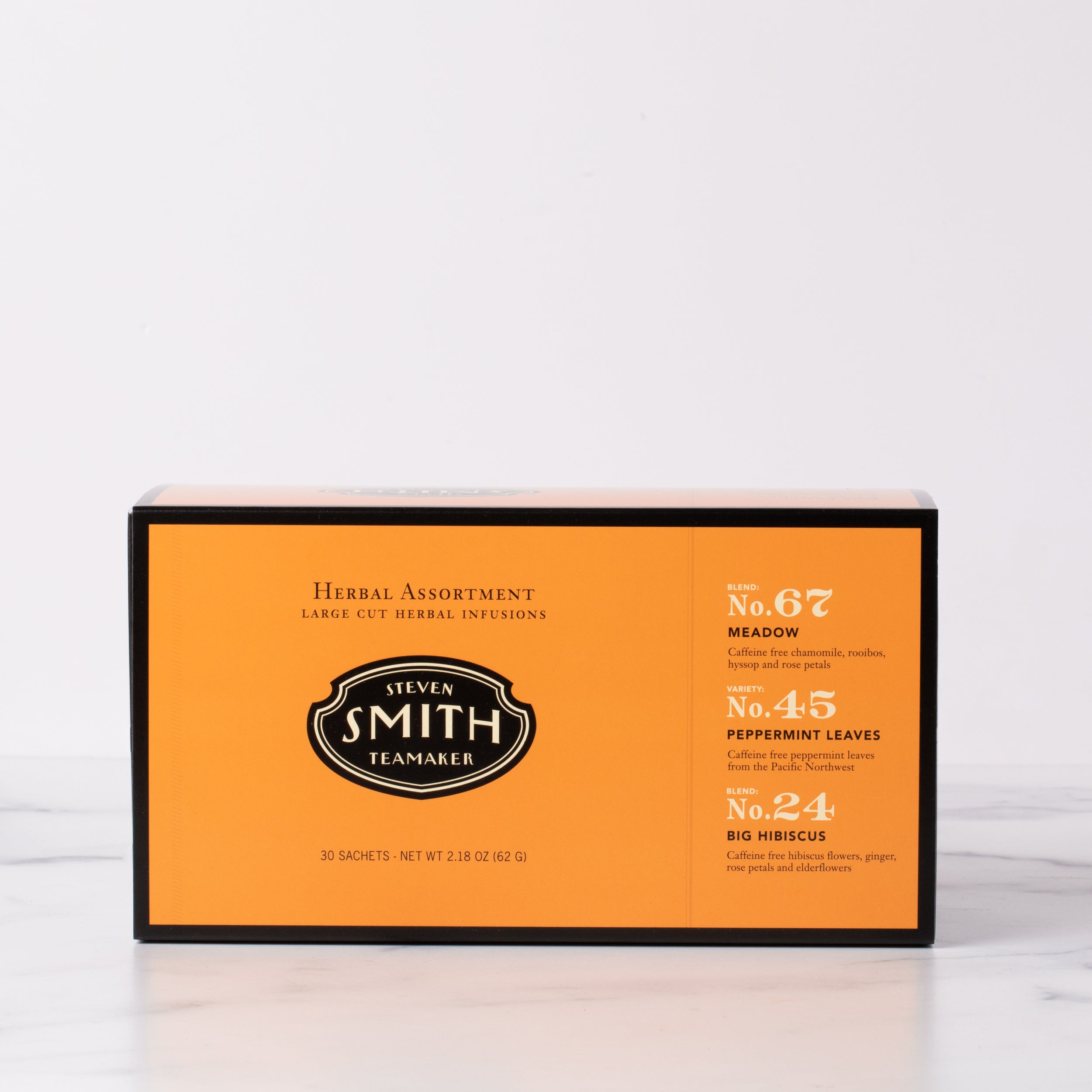Orange box with black trim on a marble table.