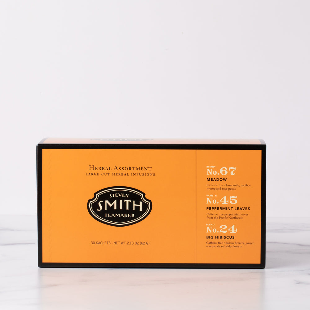 Orange box with black trim on a marble table.