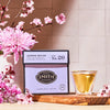 Smith Jasmine Nectar tea box with a glass of tea and pink flowers on a wooden board.