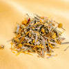 pile of Marigold tea ingredients on a yellow backdrop