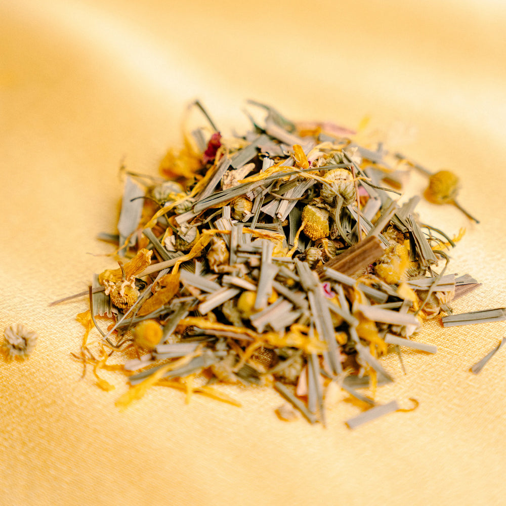pile of Marigold tea ingredients on a yellow backdrop