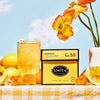Marigold in an iced glass with ingredients on a yellow and white gingham table cloth and blue skies in background. 