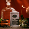 Mezcal Oolong tea canister with 'Smith' branding next to a glass teapot and match, on a warm-toned background.