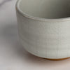 Close-up of a textured ceramic bowl on a light background