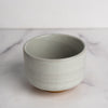 Ceramic bowl on a marble surface with a white background