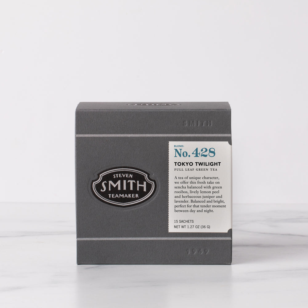 Grey gift box of Tokyo Twilight with a white label with dark blue numerology on the right side of the box and a black Smith Teamaker logo on the left.