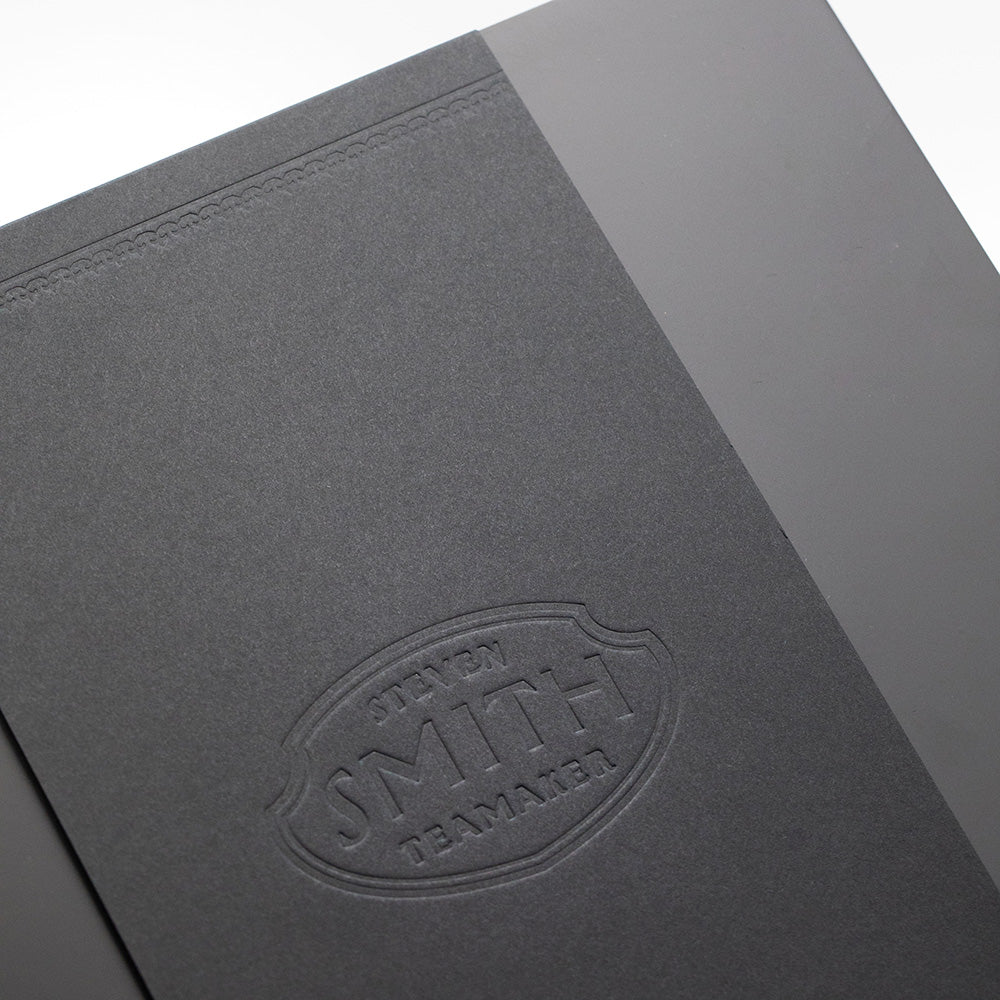 Black wooden box with logo emboss on white background.