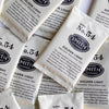 A pile of overwrapped sachets of Golden Light wellness tea.