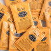 A pile of overwrapped sachets of Red Nectar herbal tea.