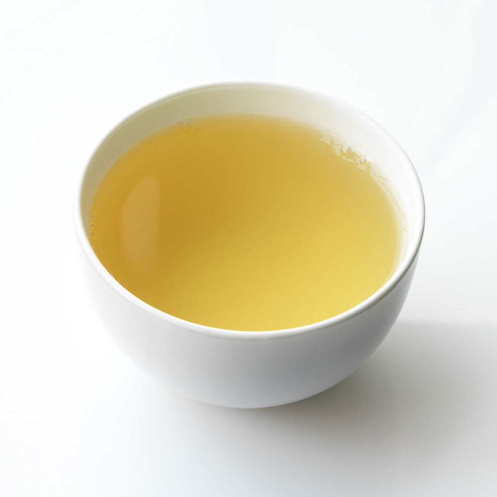 Ceramic white cup filled with Fez green tea.
